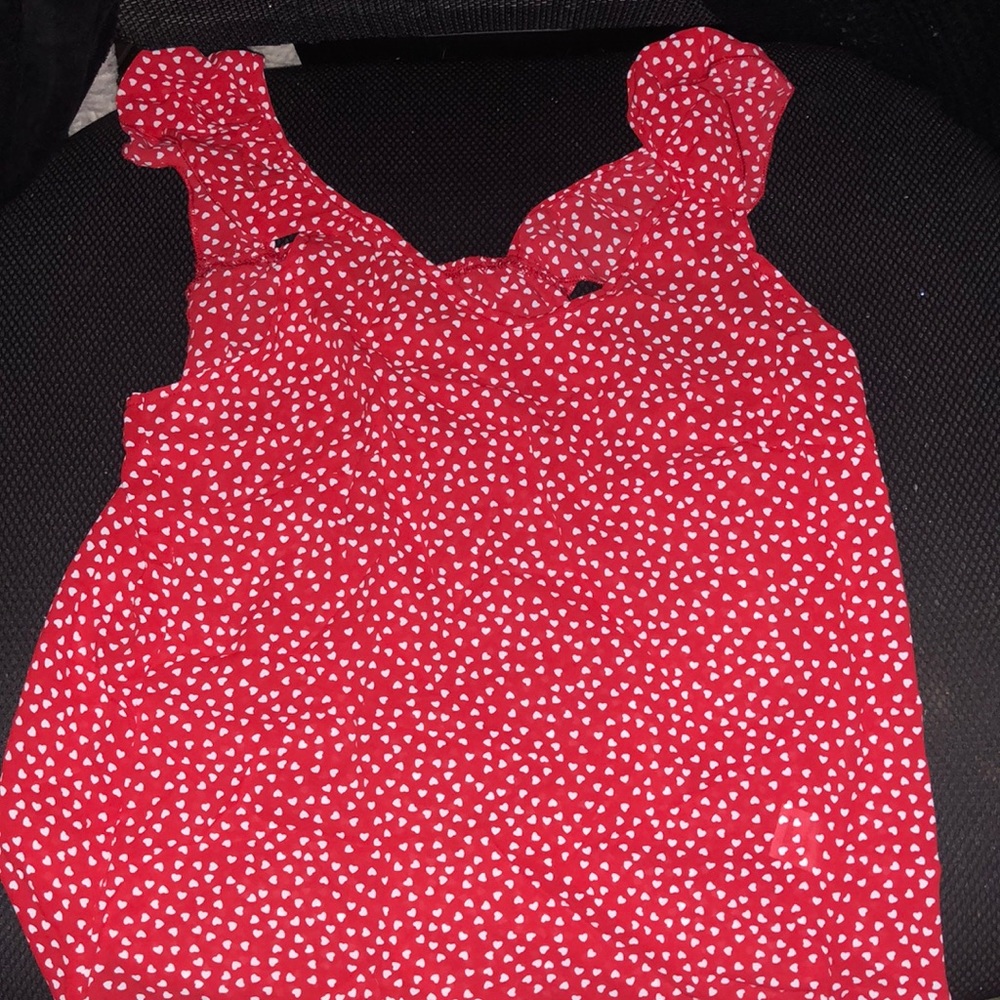 A red heart shirt with ruffly shoulders